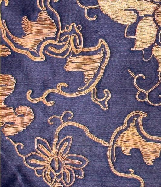 Stems and leaves of a gold-brocaded scrolling lotus